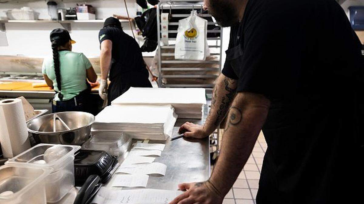 WASHINGTON, DC - AUGUST 19: Bub and Pop's part owner and chef Jon Taub looks receipts for orders placed on counter near the kitchen at Bub and Pop's on August 19, 2022 in Washington, DC. Since the beginning of Covid-19 restaurant owners have had to weather a rise in costs of supplies on top of employee turnover. According to Bub and Pop's part owner and chef Jonathan Taub, the restaurant has seen a rise in prices for products like flour and frying oil. Since 2020, some of these price points have not yet returned to their pre-pandemic levels and remain unsteady. (Photo by Anna Moneymaker/Getty Images)