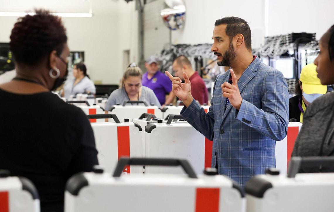 Tarrant Elections administrator Heider Garcia talks to Tarrant County employees testing voting machines on Friday.