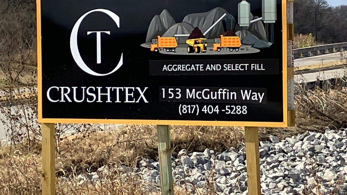 The sign for the Crushtex rock crushing operation on McGuffin Way in east Fort Worth on Jan. 5, 2026. The site is operating without a city permit while an application is pending. Residents in the area want the city to deny that request, and they want the rock crushing to stop.