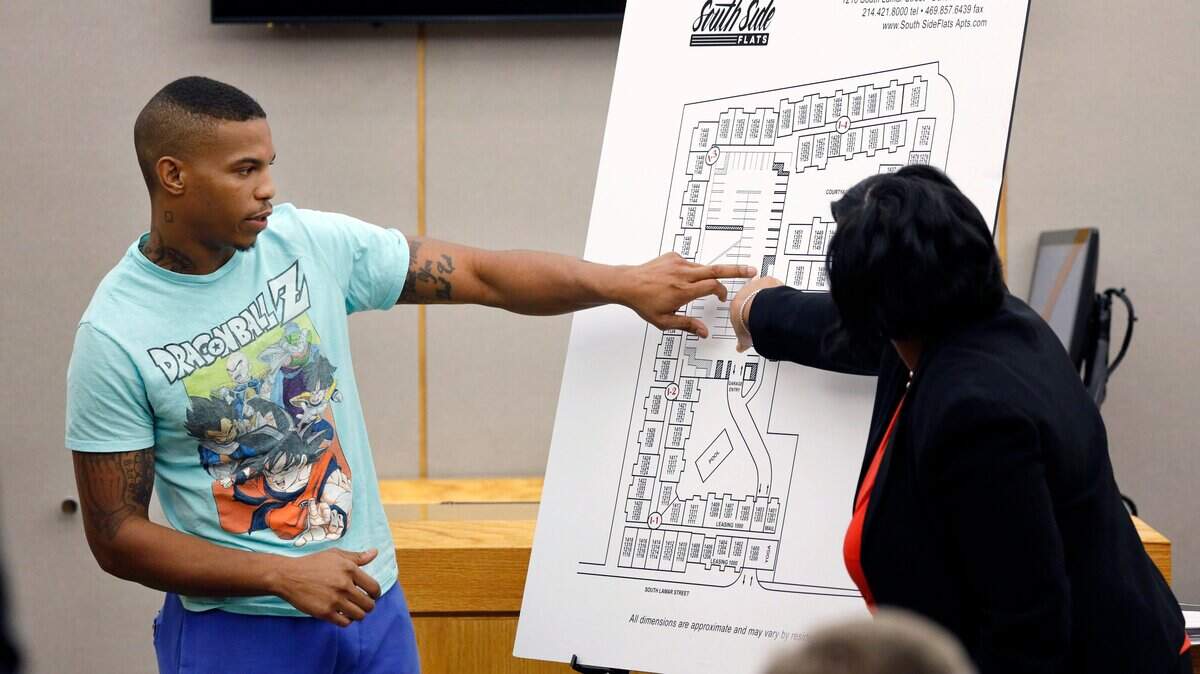 In this Tuesday, Sept. 24, 2019, photo, victim Botham Jean’s neighbor Joshua Brown, left, answers questions from Assistant District Attorney LaQuita Long, right, while pointing to a map of the South Side Flats where he lived, while testifying during the murder trial of former Dallas Police Officer Amber Guyger, in Dallas. Brown was later killed in a shooting on Oct. 4., 2019. (Tom Fox/The Dallas Morning News)
