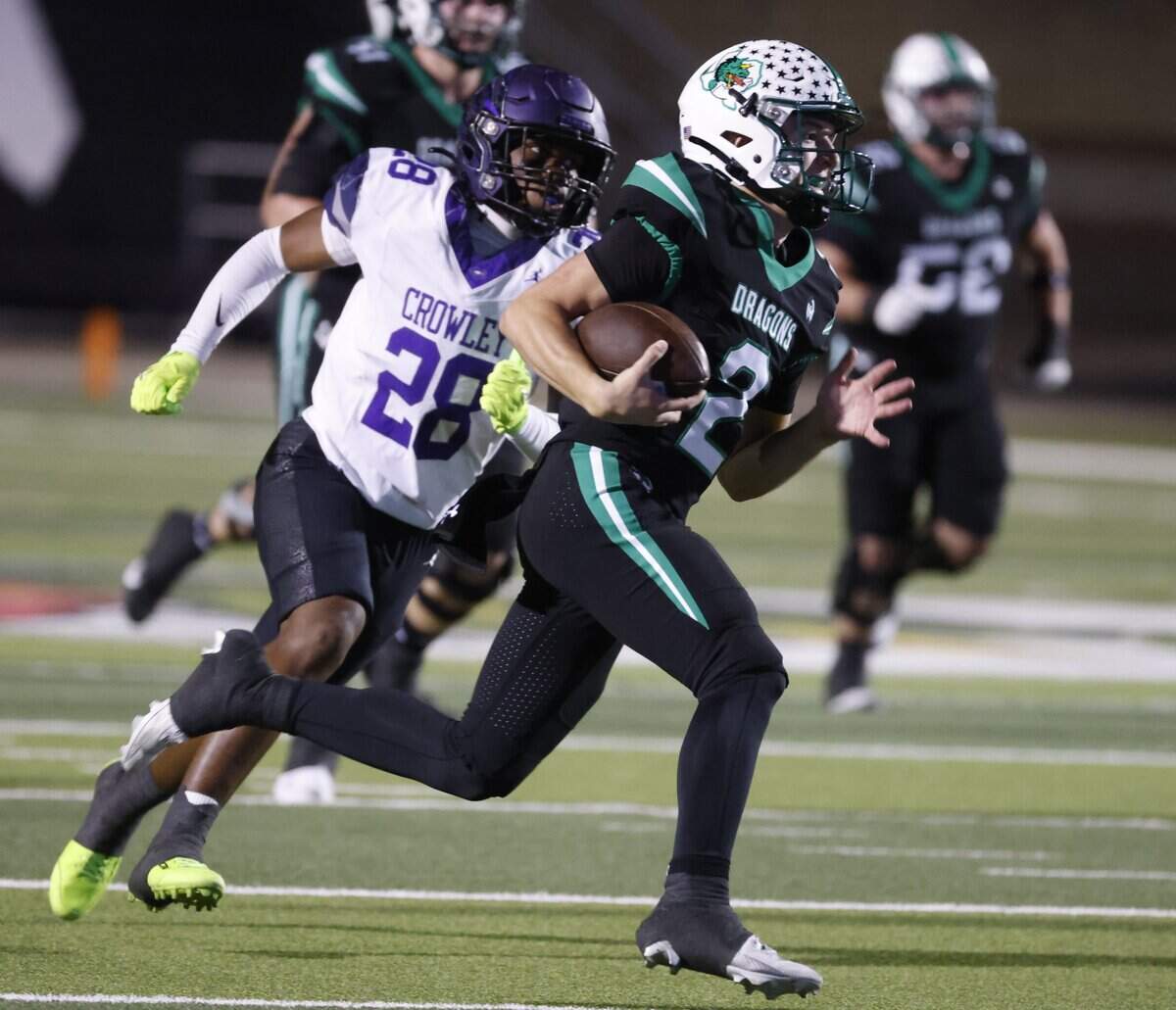 Crowley outside linebacker Tyler Hooper (28) chases Southlake quarterback Angelo Renda (2) across the field during the second half of a UIL Conference 6A D2 Bi-District playoff game between Crowley and Southlake Carroll at Dragon Stadium in Southlake, Texas, Thursday, Nov. 13, 2025.