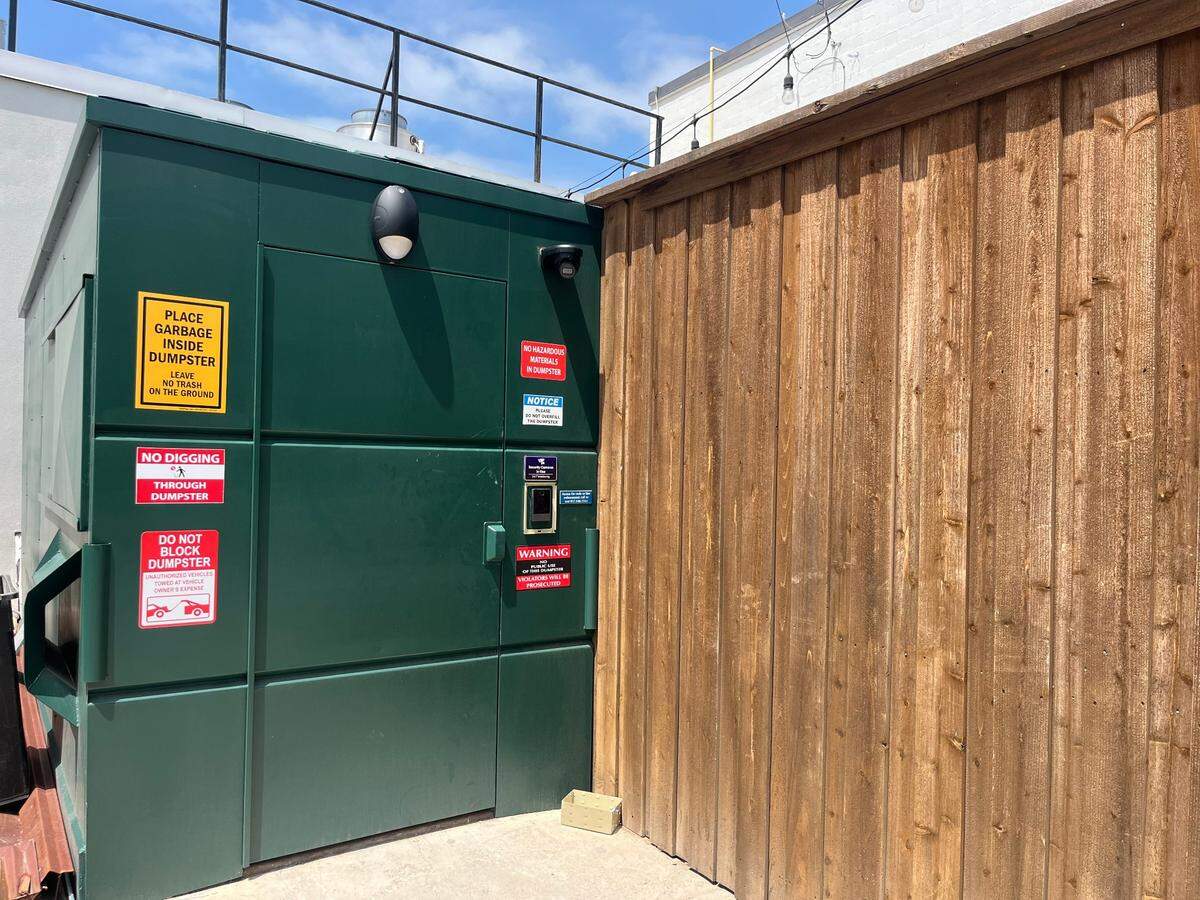 Entrance to No Vacancy is through this green dumpster. The new speakeasy bar will open mid to late summer 2025.