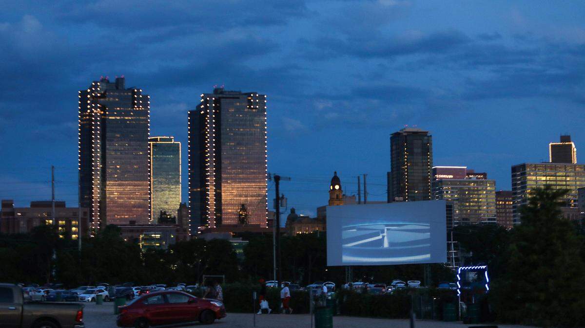 The sun sets as a movie begins at one of four screens at Coyote Drive-In movie theater on Wednesday, May 27, 2020, in Fort Worth. Harry Potter movies are showing at the drive-in now until Nov. 10, 2022.