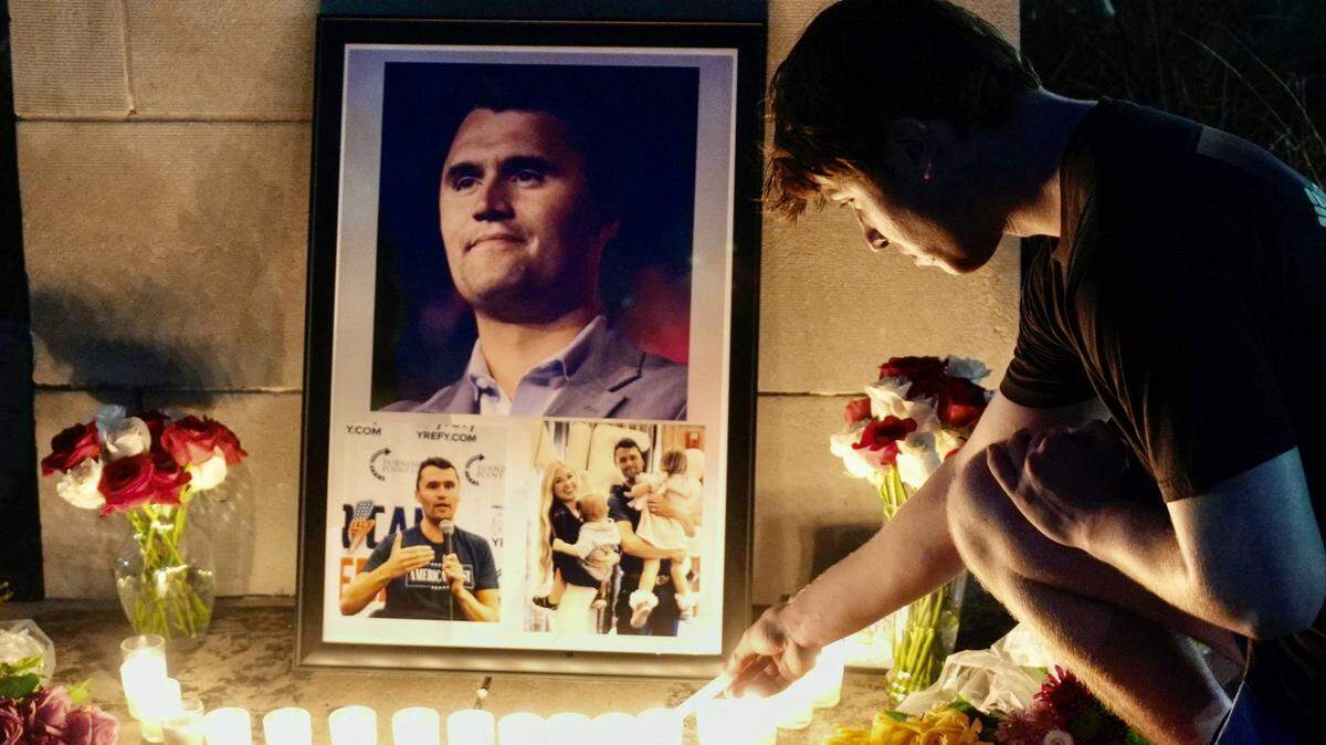 Kalib Magana, president of the University of Oklahoma’s chapter of Turning Point USA, lights a candle during a vigil for Charlie Kirk on Wednesday, Sep. 10, 2025, at the University of Oklahoma in Norman. Kirk, the founder of Turning Point USA, was killed by a gunshot wound to the neck while speaking at Utah Valley University.