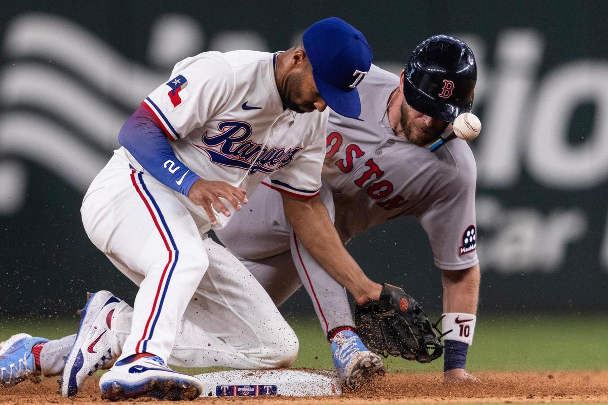 Rangers second baseman Marcus Semien (2) fails to tag out Red Sox short stop Trevor Story (10) on a steal attempt in the ninth inning of the MLB Opening Day game between the Rangers and Red Sox at Globe Life Field in Arlington on Thursday, March 27, 2025.