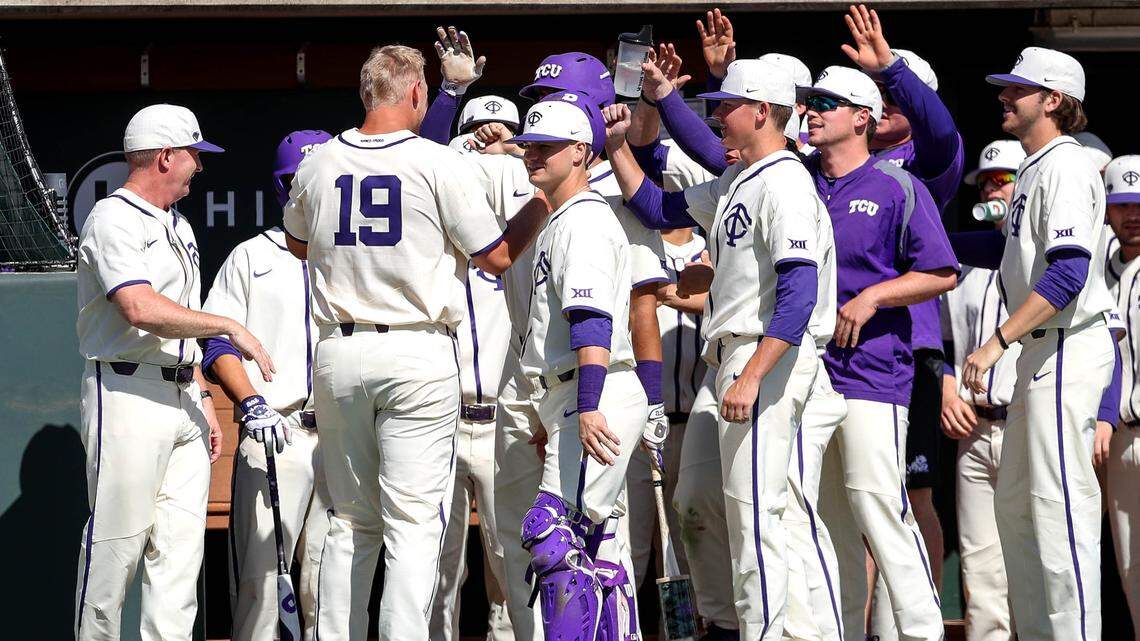 TCU first baseman Luken Baker (19) is congratulated by his teammates after scoring a run in the first inning against Long Beach State Sunday afternoon, February 25, 2018 played at Lupton Stadium.