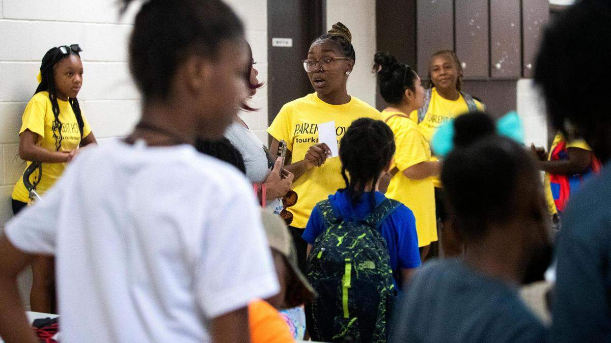 Trenace Dorsey-Hollins, a Powerful Parents Movement member, talks to another parent during a back-to-school fair about the state of schools in Fort Worth, Texas, on Saturday, Aug. 13, 2022.