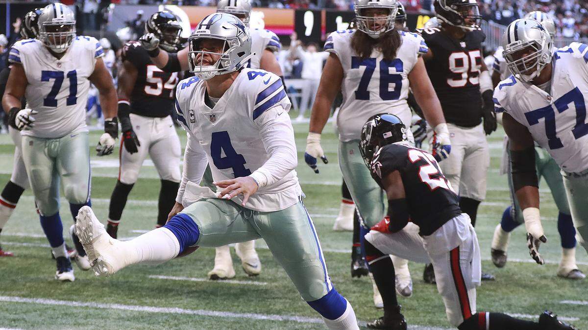Dallas Cowboys quarterback Dak Prescott reacts to scoring a touchdown on a quarterback keeper past Atlanta Falcons safety Damontae Kazee during the fourth quarter of an NFL football game Sunday, Nov. 18, 2018, in Atlanta. Dallas won 22-19.