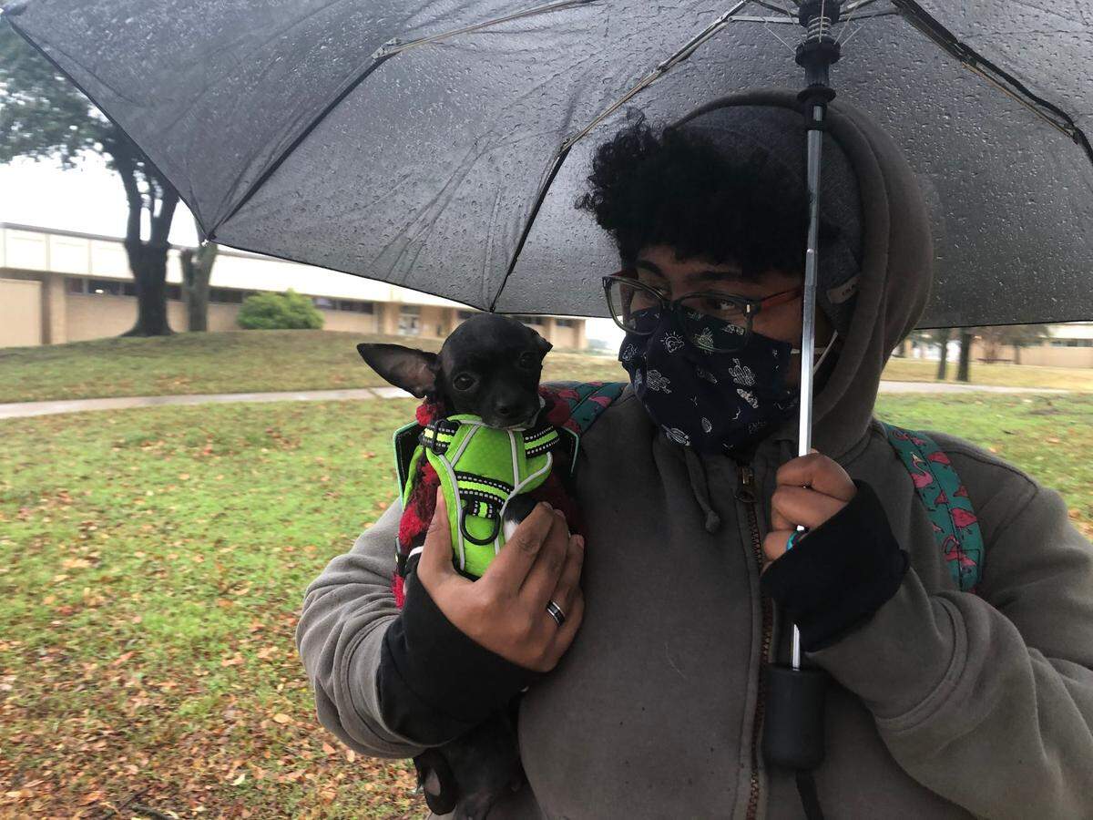 Stevie Cezar, 27, waited in line for the COVID-19 vaccination on Dec. 31 with her dog, Mouse. She said the wait was worth it for the vaccine.
