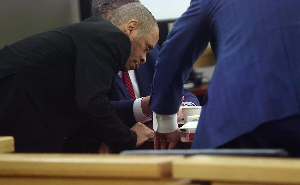James Floyd Jr. confers with his standby lawyers while representing himself while on trial for aggravated robbery on Thursday, March 31, 2022, at the Tim Curry Criminal Justice Center in Fort Worth. Floyd is also charged with capital murder.