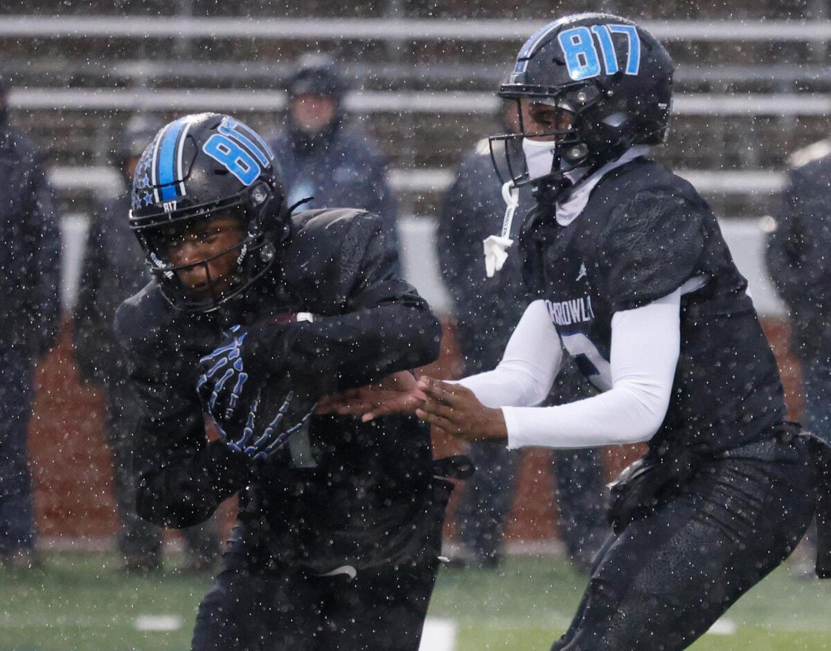 North Crowley running back Cornelius Warren (1) takes the hand off from quarterback Chris Jimerson (12) during the UIL 6A D1 Quarterfinals at Vernon Newsom Stadium in Mansfield, Texas, Saturday, Dec. 07, 2024.
