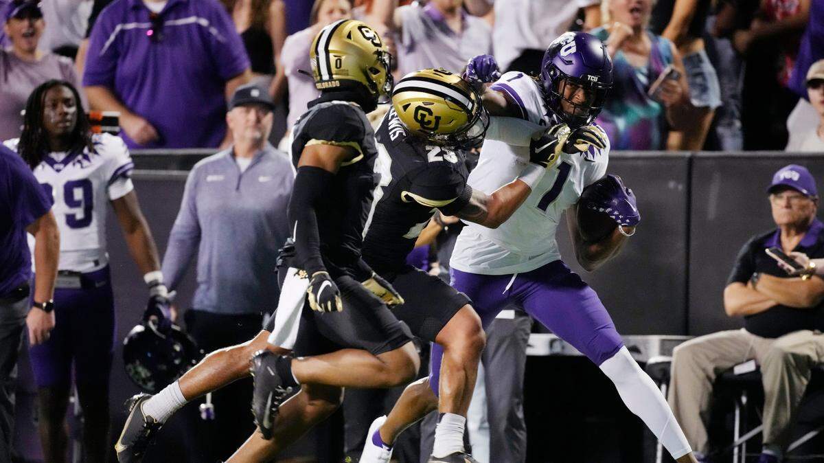 TCU wide receiver Quentin Johnston, right, is stopped by Colorado safety Isaiah Lewis as cornerback Kaylin Moore watches during the first half of an NCAA college football game Friday, Sept. 2, 2022, in Boulder, Colo.