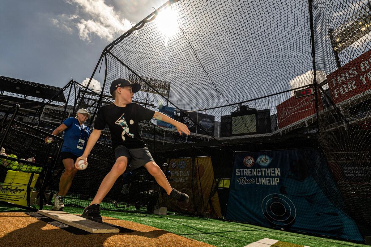 Arlington resident Caden Pollitte, 9, tests his arm strength during the pitch speed simulator for the first day of the 2024 MLB All-Star Village at Choctaw Stadium in Arlington on Saturday, July 13, 2024.