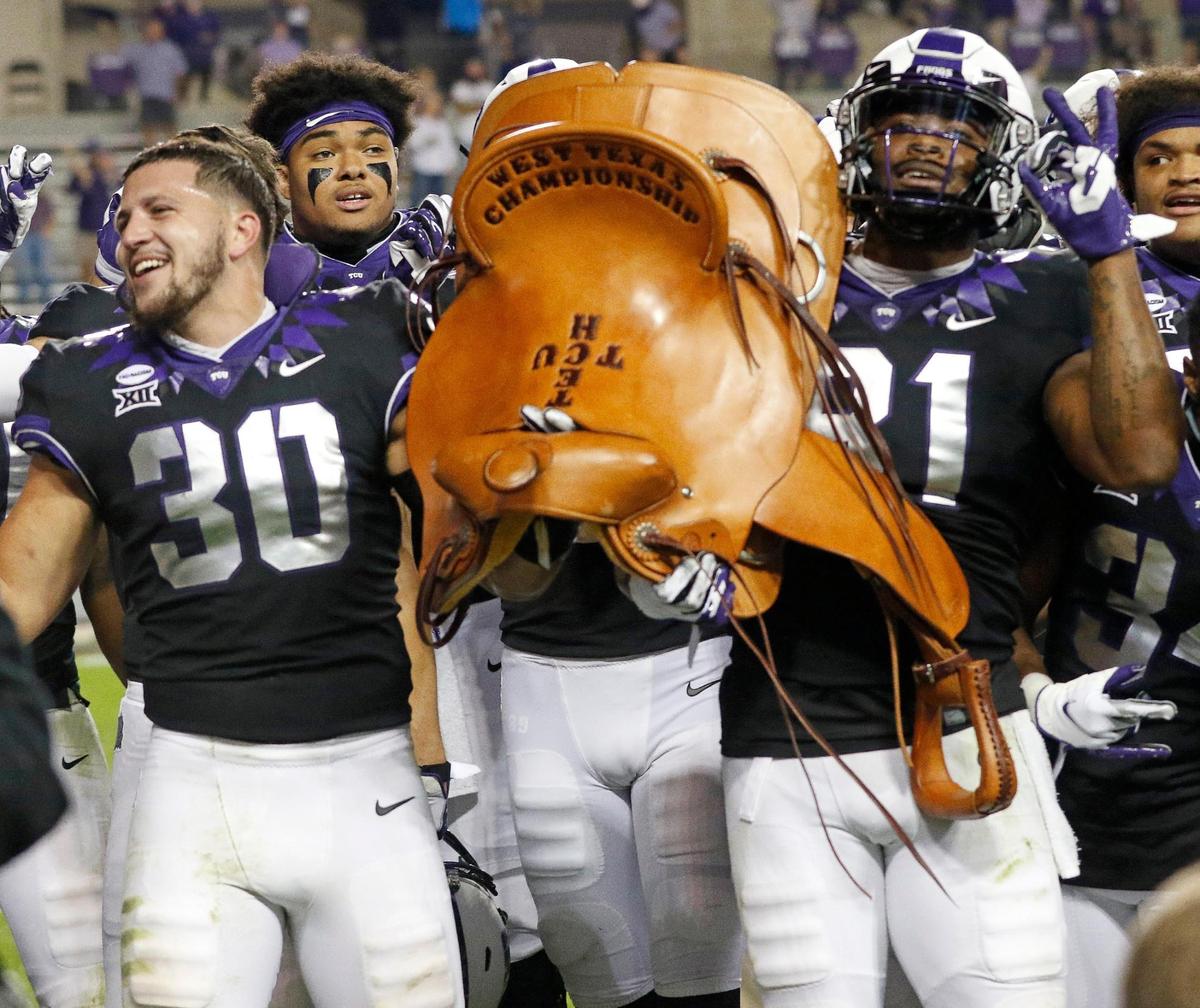 TCU linebacker Garret Wallow (30) and tight end Pro Wells (81) hold the Saddle Trophy after defeating Texas Tech in a NCAA college football game at Amon G. Carter Stadium in Fort Worth, Texas, Saturday, Nov. 07, 2020. TCU defeated Texas Tech 34-18. for their first season home win. (Special to the Star-Telegram Bob Booth)