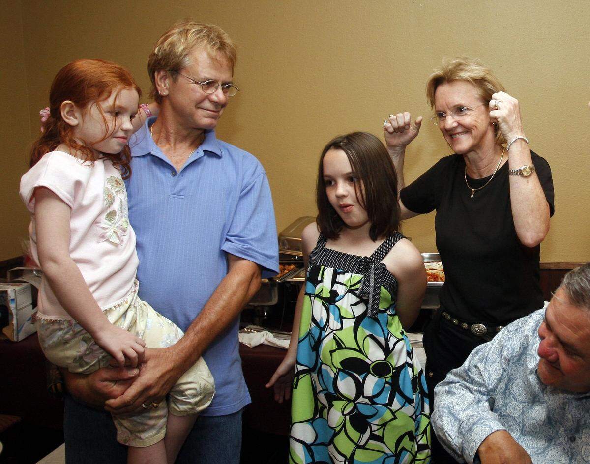 May 8, 2010: From left, Zoie Jackson, 6; Bruce Jackson; and Alexis Jackson, 10; look on as Tobi Jackson raises her arms triumphantly at her party at Italy Pizza and Pasta. Jackson defeated Jean McClung in the Fort Worth ISD district 2 election.