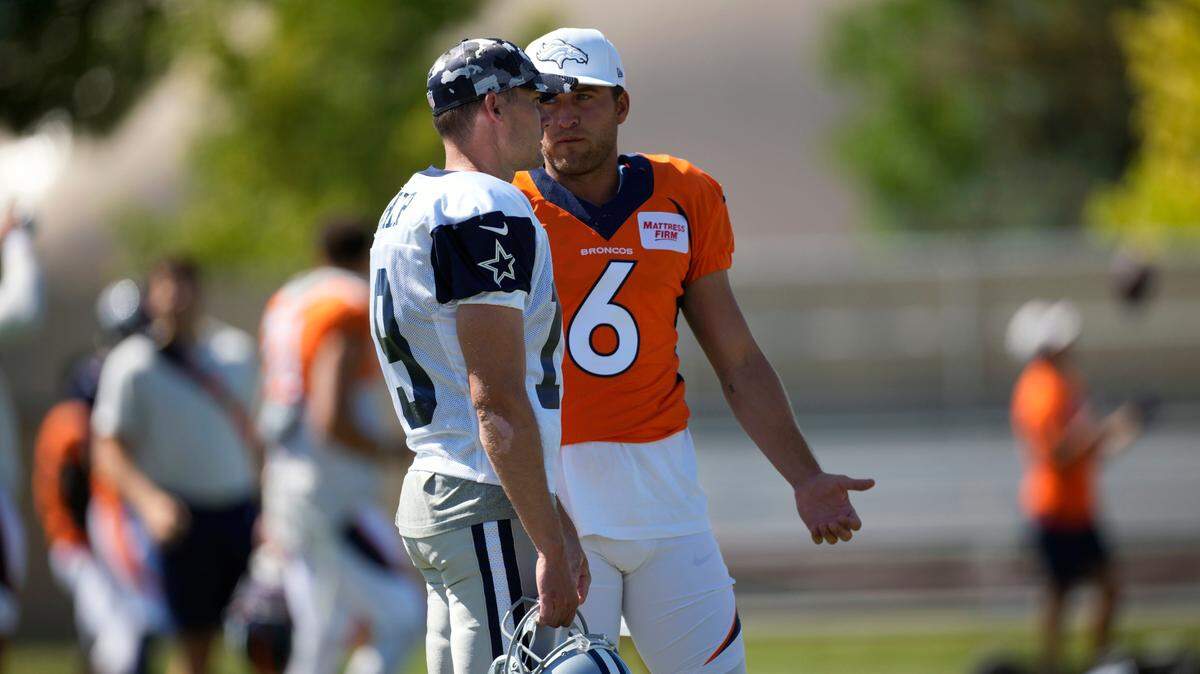 Dallas Cowboys place kicker Brett Maher, front, chats with Denver Broncos punter Sam Martin during their practice on Aug. 11.