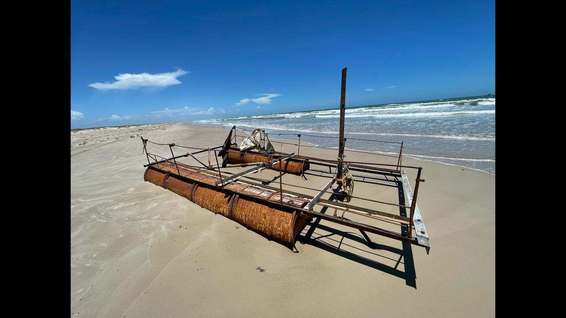 The makeshift raft has a broken tree branch for a mast.