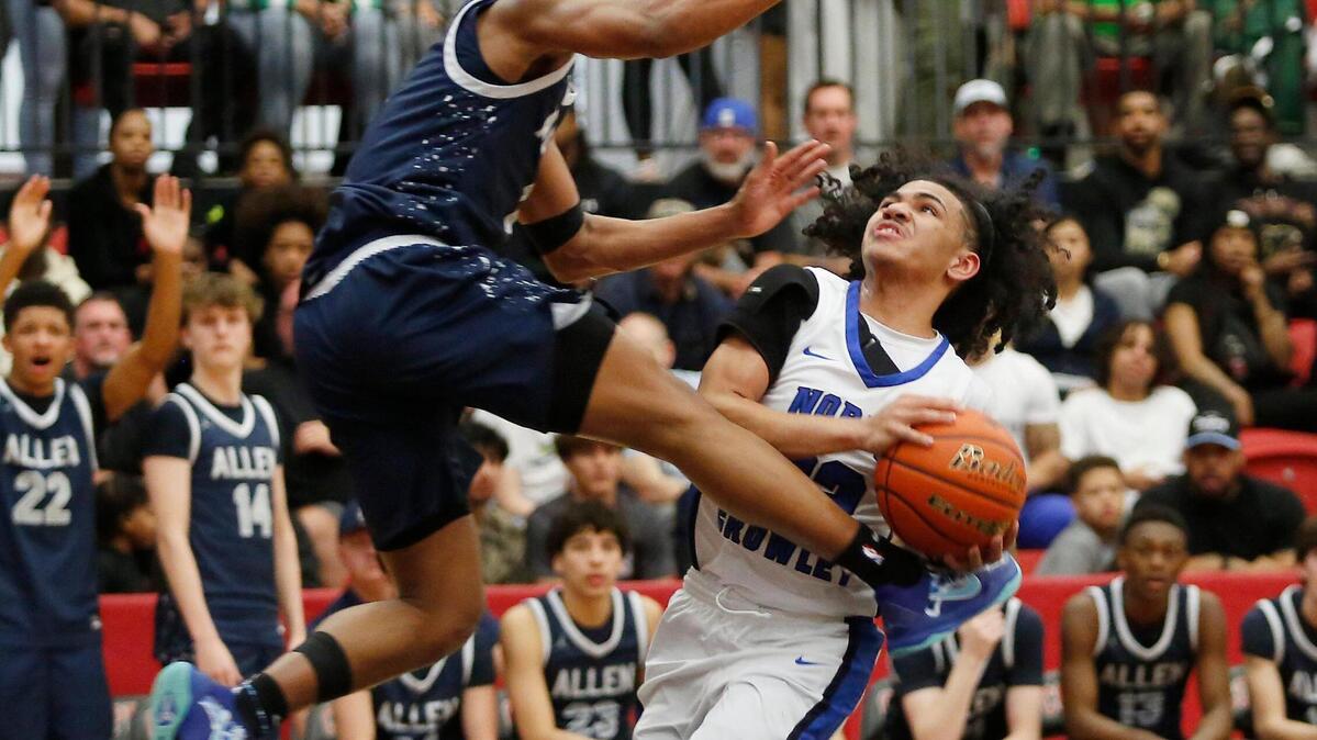 North Crowley’s Isaak Hayes drives the lane as Allen’s Trent Pane defends during their Class 6A 1D Regional Semi Final game on Tuesday night at Coppell High School.
