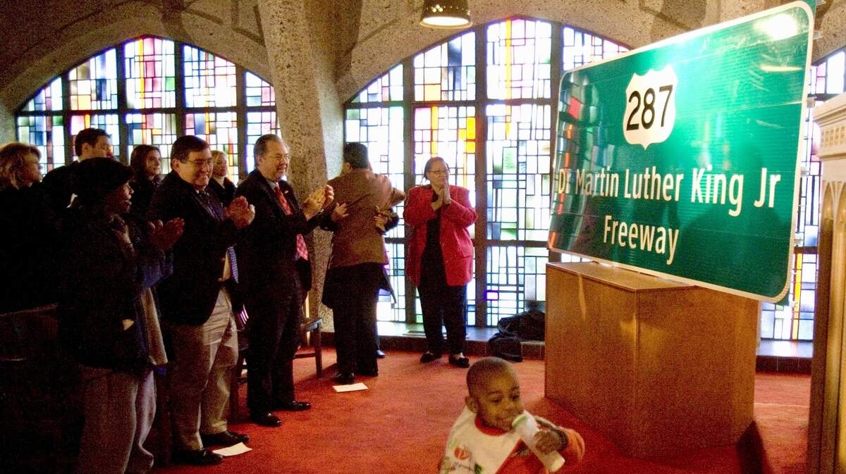 A crowd applauds after the Dr. Martin Luther King, Jr. Freeway sign unveiling ceremony at the Masonic Home Chapel in Fort Worth on Monday, January 15, 2007.