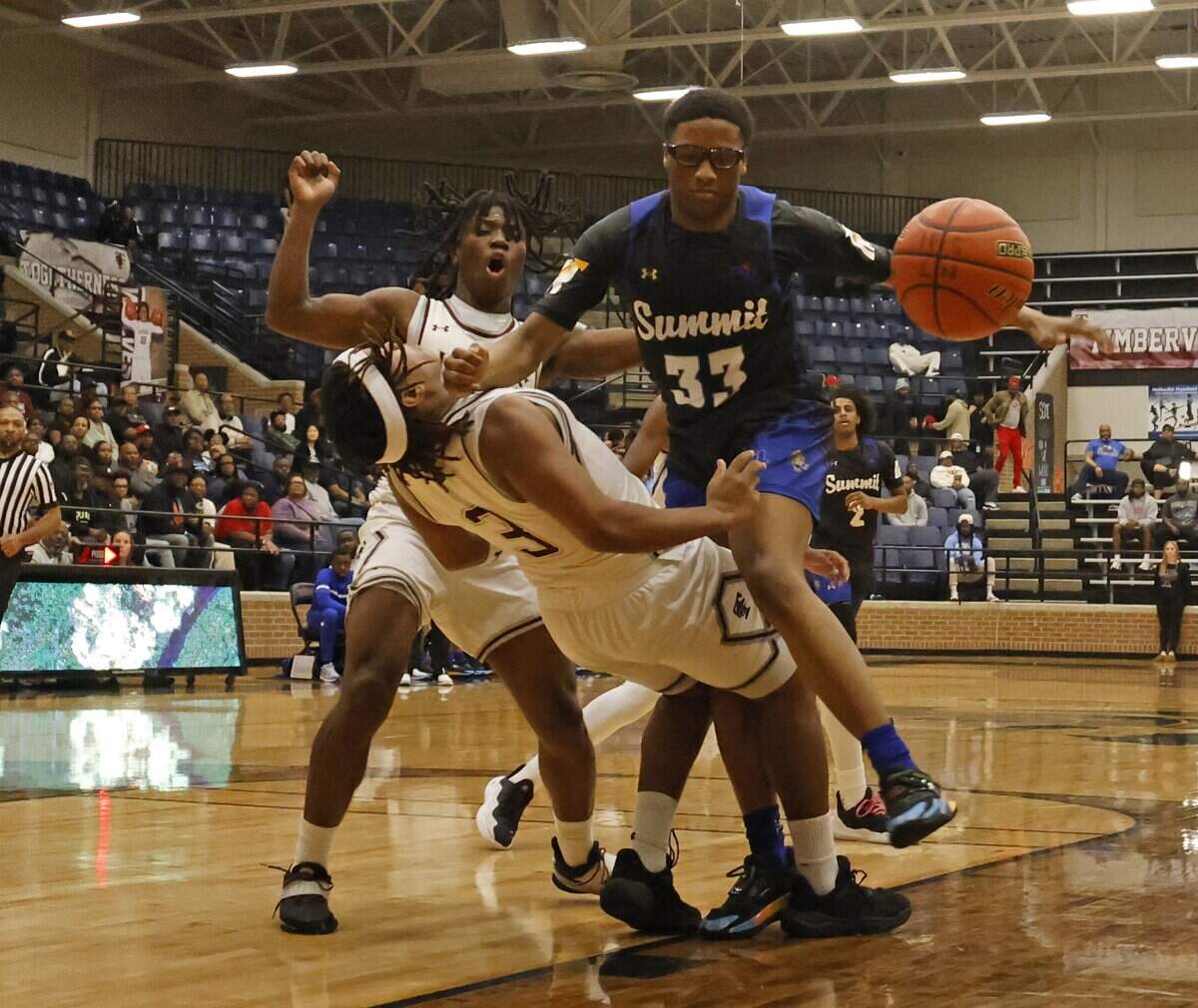 Mansfield Summit guard Javon Ross (33) is called for charging against Mansfield Timberview guard Grant Nash (3) during the first half of a UIL boys basketball game at Mansfield Timberview High School in Arlington, Texas, Tuesday Feb. 10, 2026.