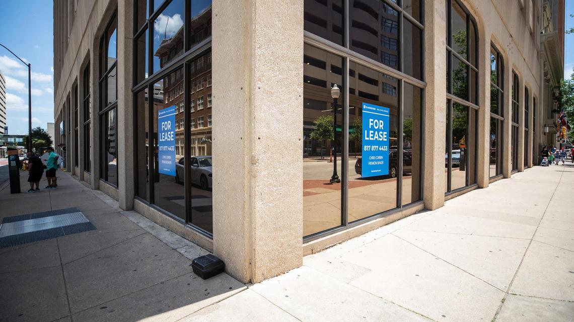 A smattering of tourists walk past a vacant storefront in downtown Fort Worth. Nearly a third of the city’s downtown storefronts are closed.