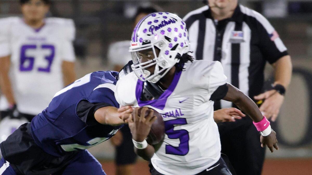 Paschal quarterback Jashaun Thomas (5) escapes the Wyatt defense during a District 4-5A Division 1 football game at Herman Clark Stadium in Fort Worth, Texas, Thursday, Oct. 24, 2024.