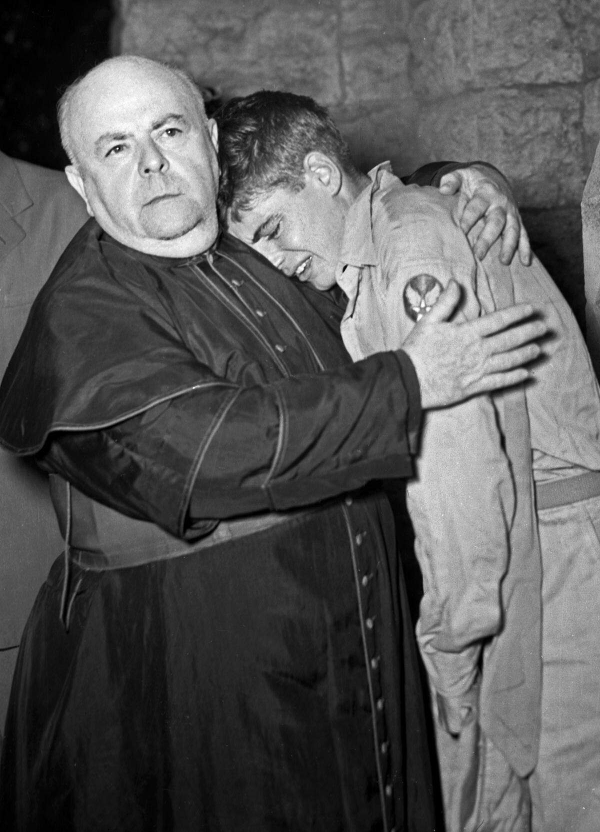 After receiving news of the Japanese surrender on Aug. 14, 1945, Pvt. George Beaudoux, 18, is shown collapsing in the arms of Mons. J. G. O’Donohoe of St. Patrick’s Catholic Church. Beaudoux’s brother, a Marine, was killed on Iwo Jima.