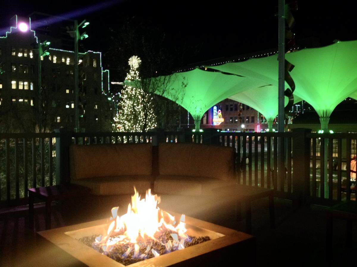 The view from Bird Cafe’s firepit of the Sundance Plaza umbrellas, tree and clock tower.