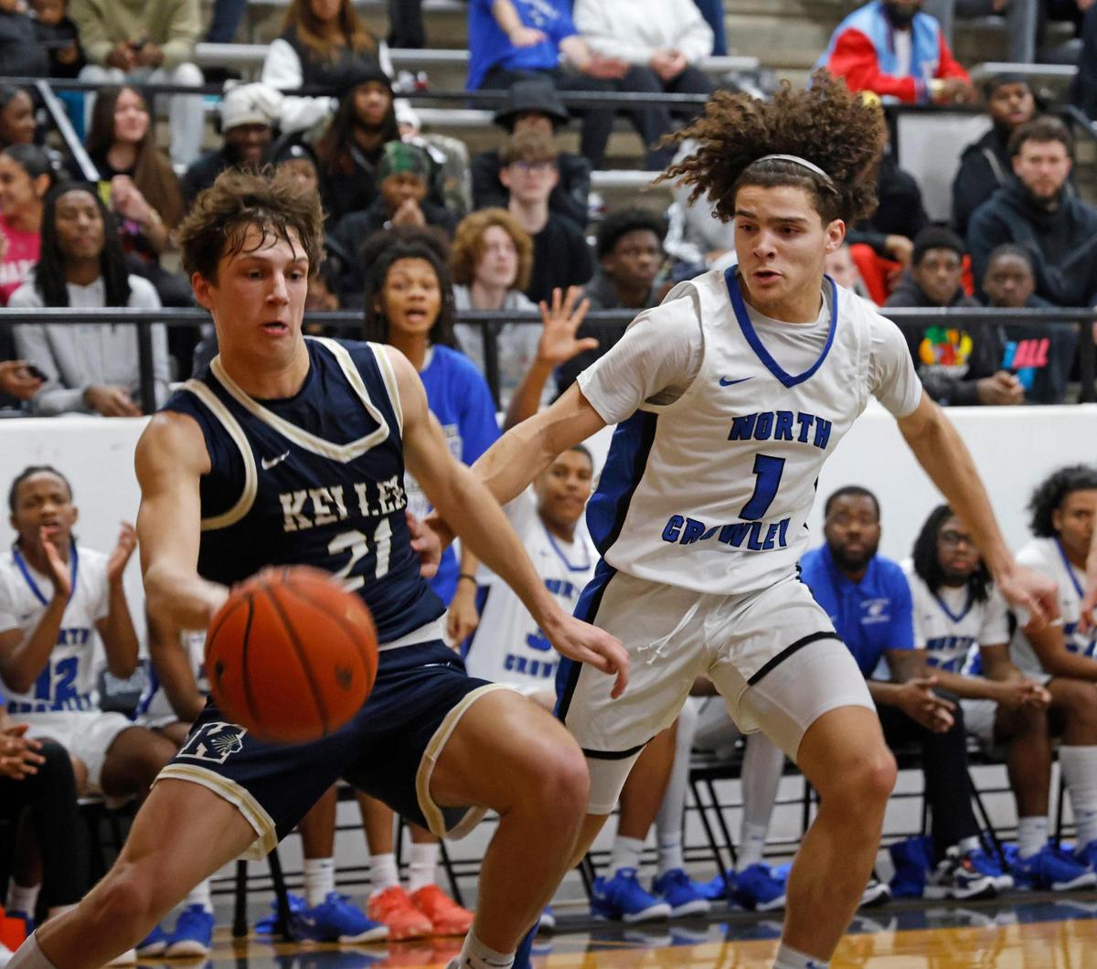 North Crowley guard Abram Hicks (1) guards Keller point guard Cash Erdmann (21) during the first half of the UIL 6A Region I Bi-District playoff game at Martin High School in Arlington, Texas, Monday, Feb. 17, 2025.
