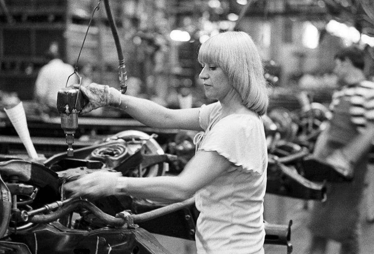 June 7, 1978: Kathy Ray installs front lower control arm bumpers at the GM Arlington Assembly plant.