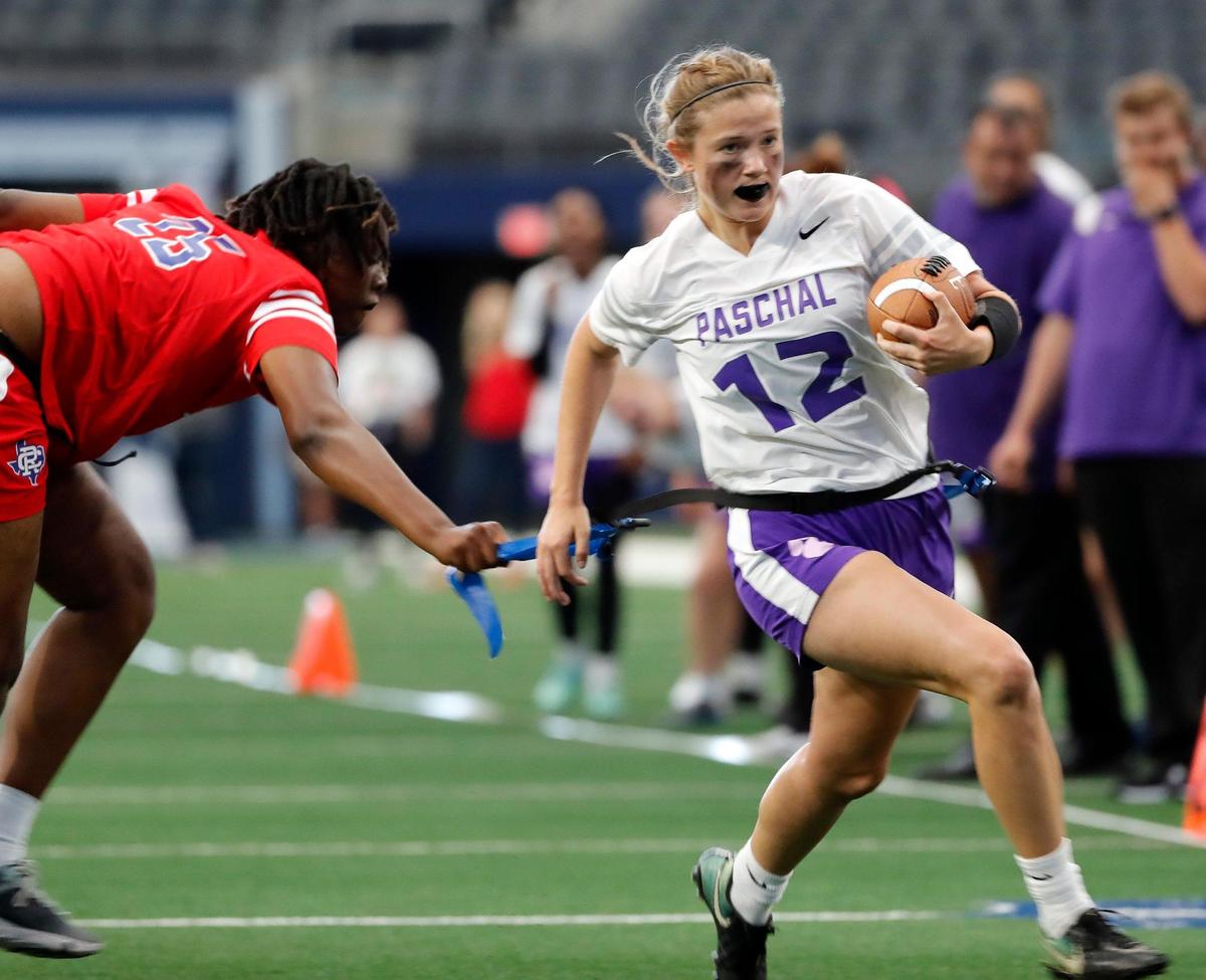Carter-Riverside defender Kieanna Criss grabs the flag of Paschal runner Sky Crackett during a Fort Worth ISD flag football game at ATT Stadium in Arlington, Texas, Wednesday, May 18, 2022. Paschal defeated Carter Riverside 33-13. (Special to the Star-Telegram Bob Booth)