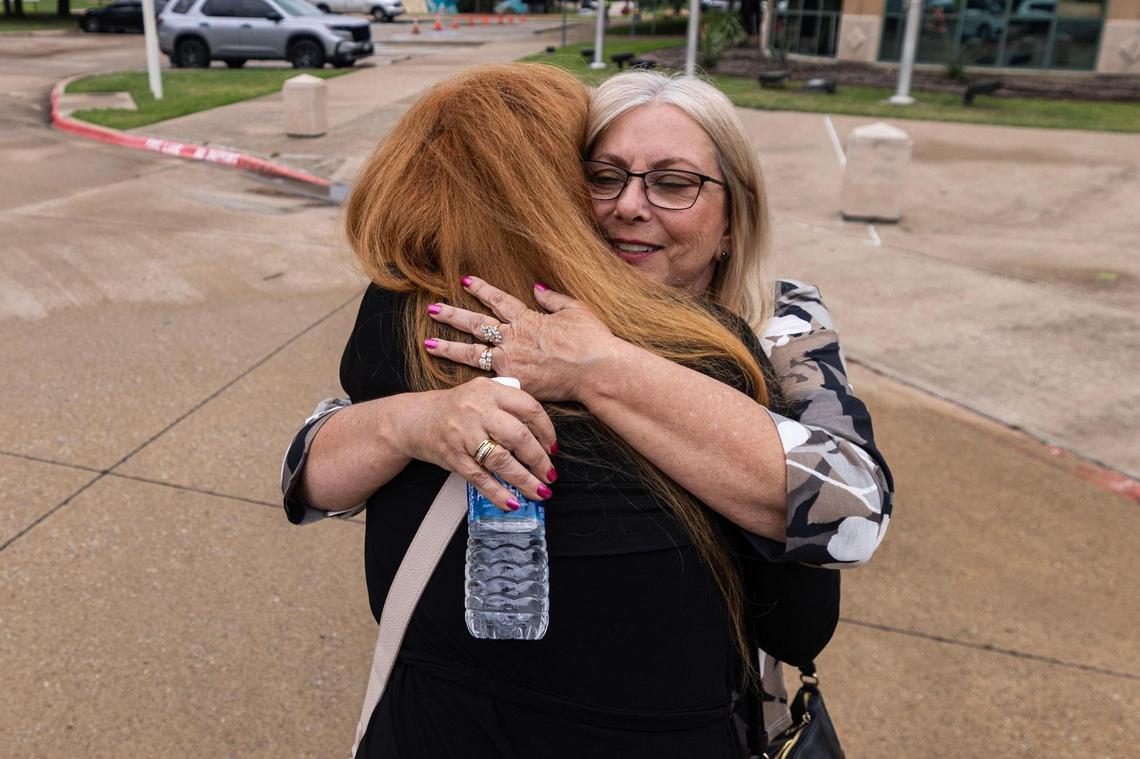 Bridget Johns Scott, left, and Kelly Chance, right, embrace after a news conference outside the Irving Police Department on Wednesday, June 11, 2025, announcing an arrest in the 1994 murder of Megan Johns. Chance was a high school friend of Megan Johns, and Scott is her younger half-sister. The two have spent the past 30 years advocating for the case to be solved.