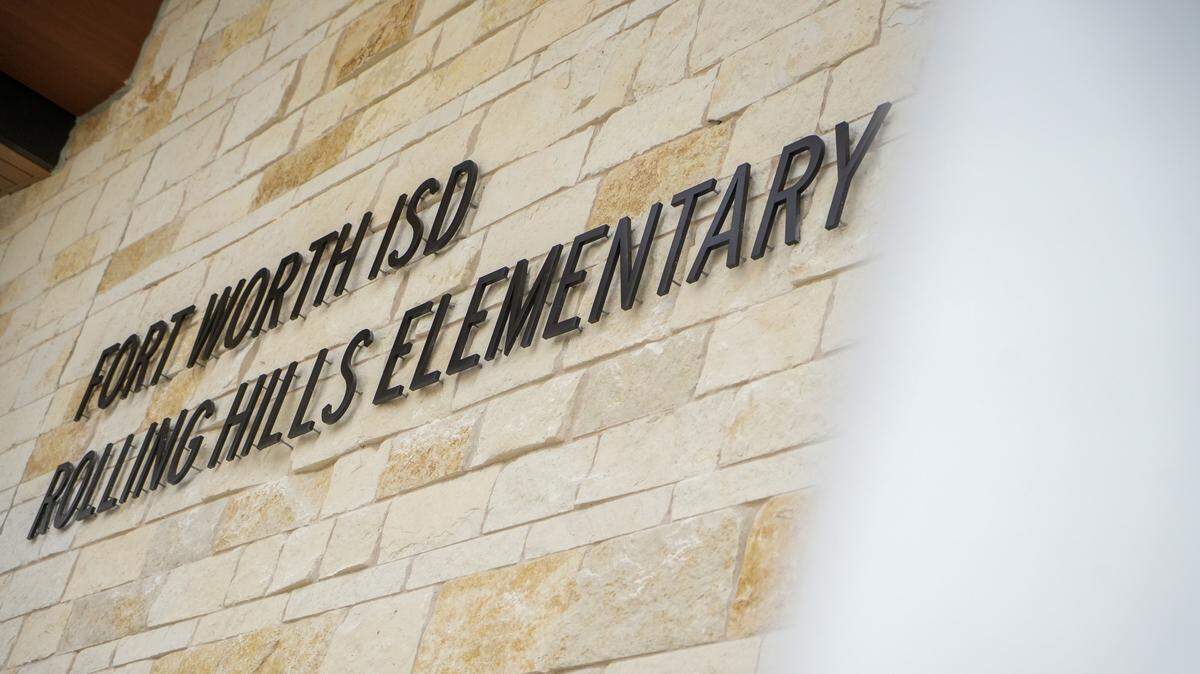 "Fort Worth ISD Rolling Hills Elementary" is spelled out in black lettering on a tan brick wall.