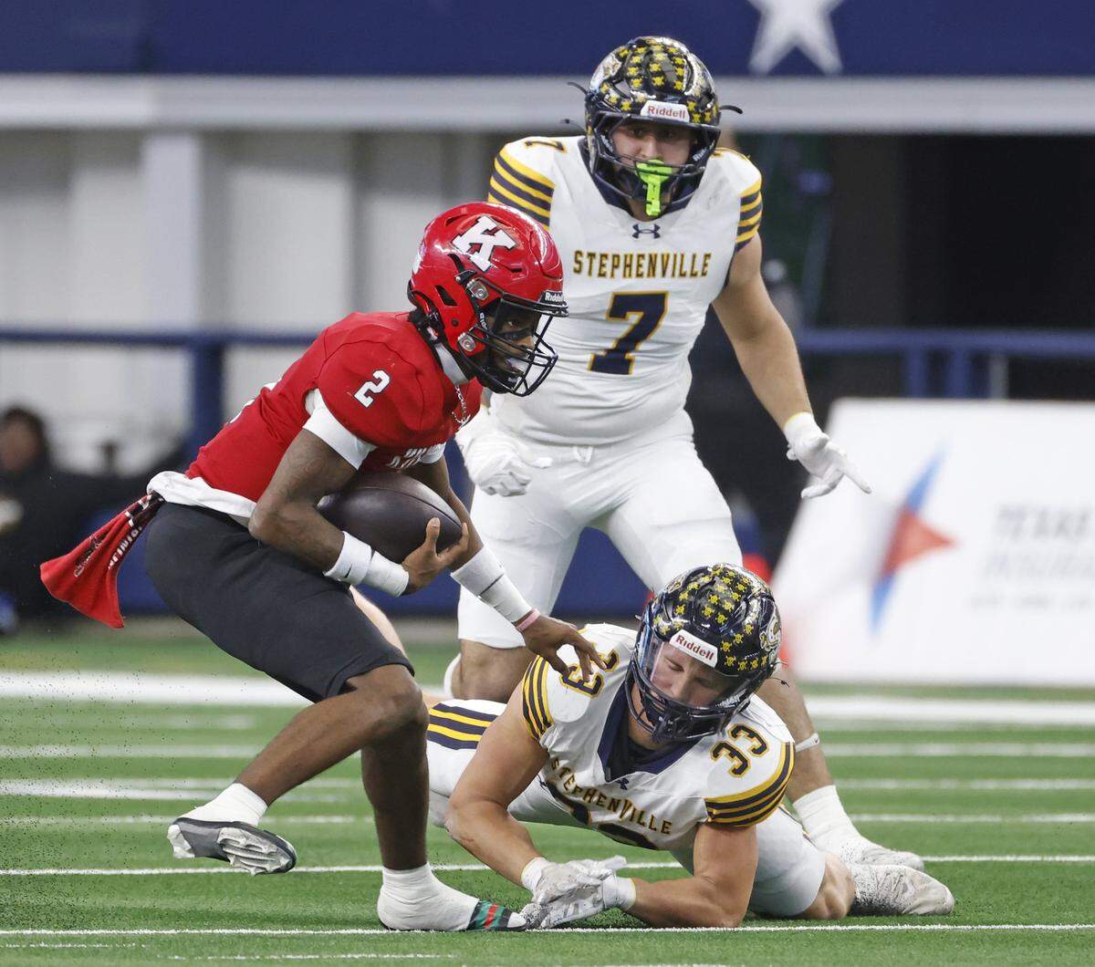 Kilgore quarterback Kayson Brooks (2) bypasses the tackle from Stephenville linebacker Caleb Taylor (33) during the first half of the UIL Class 4A Division I championship game on Friday Dec. 19, 2025 at AT&T Stadium in Arlington, Texas.