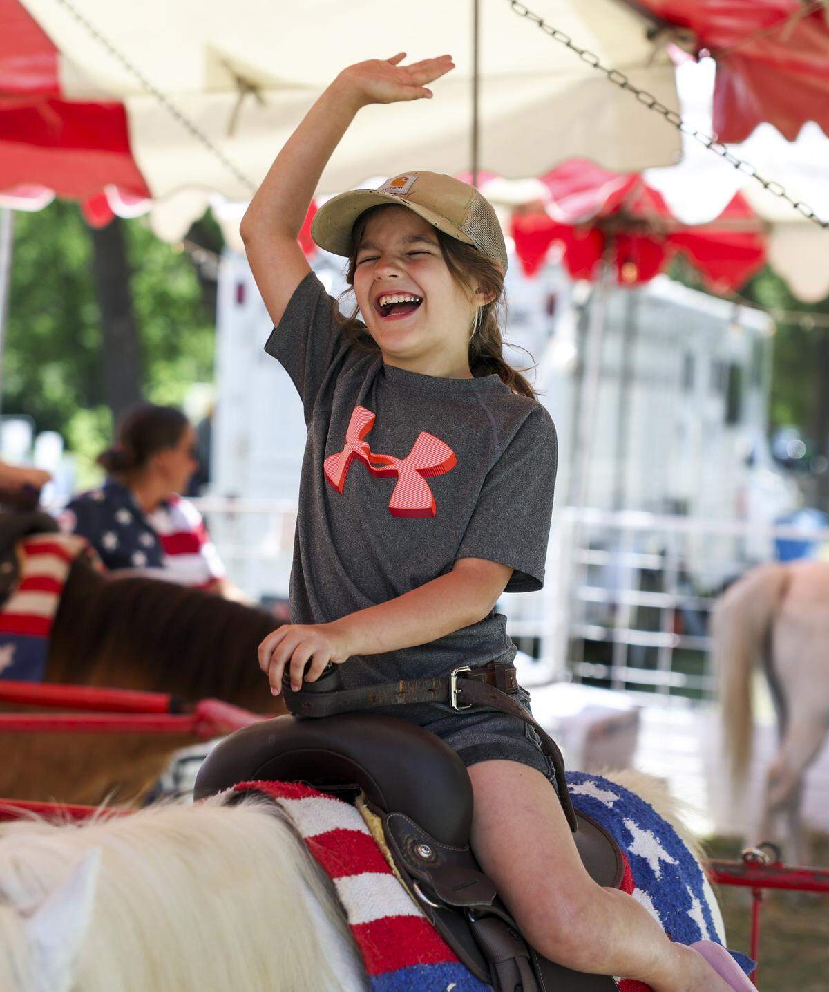 Keiaula Rincon, 8, rides a pony at Mayfest on Saturday, May 2, 2026, in Fort Worth, Texas. Mayfest brings live music, carnival rides, food, local art and more along the Trinity River.