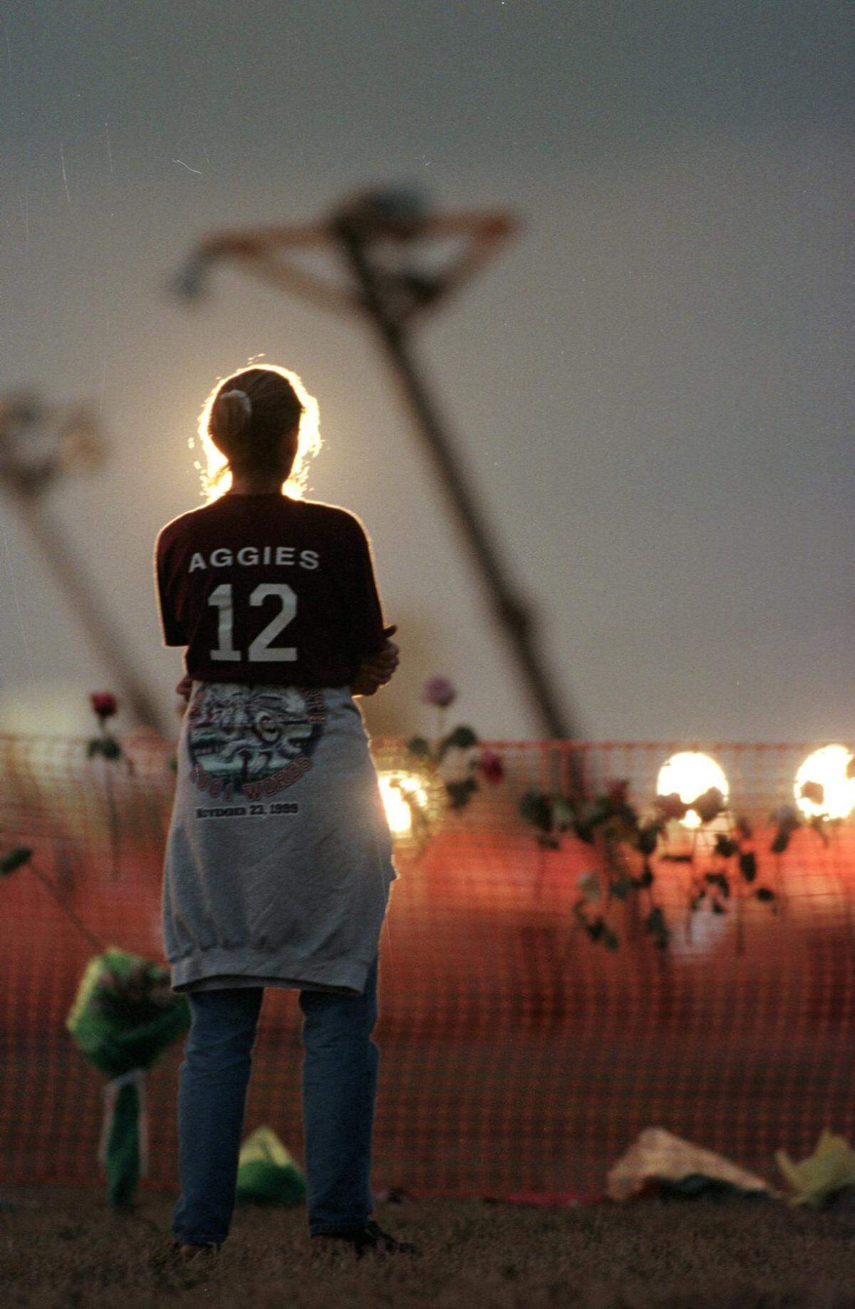 Students gathered to pay their respects at dusk on the scene where 12 students were killed at the bonfire accident at Texas A&M University in College Station on Nov. 18, 1999.