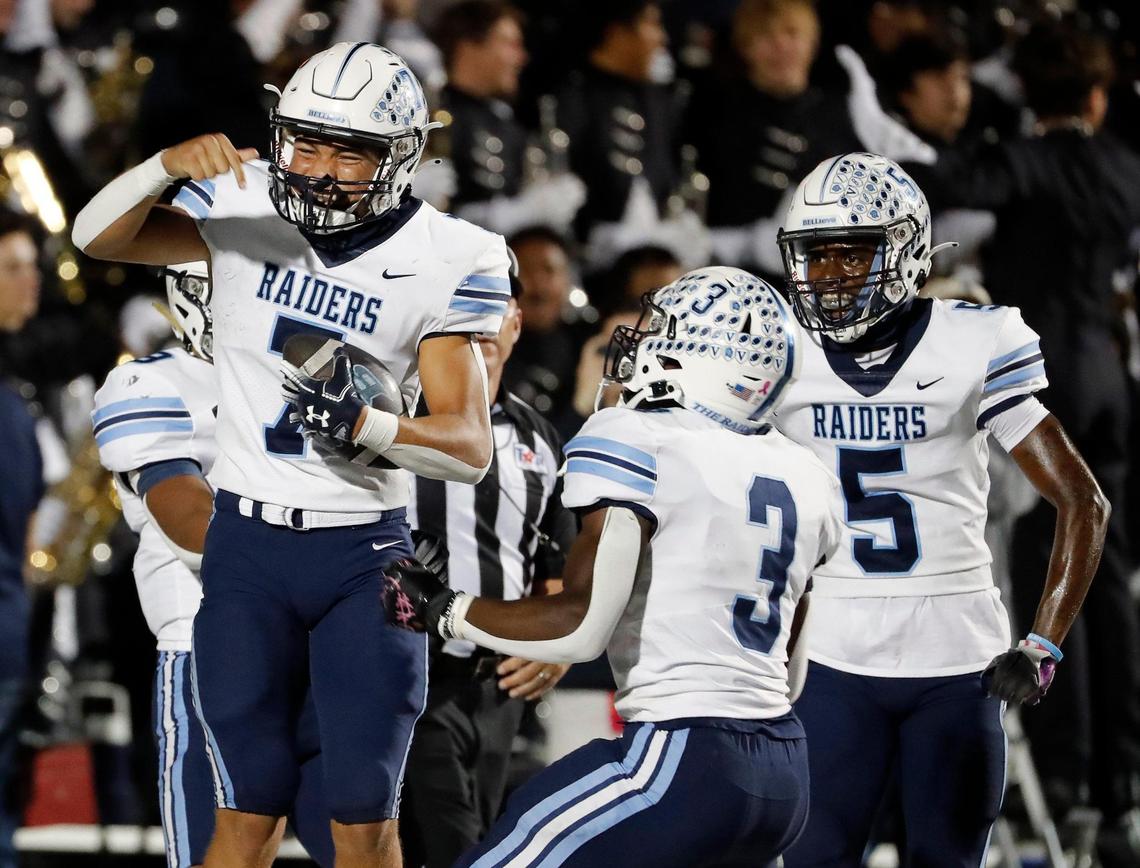 L.D. Bell quarterback Maddox Olatunde (7) celebrates their first touchdown in the first half of a District 3-6A high school football game at Pennington Field in Bedford, Texas, Thursday, Nov. 03, 2022. Trinity led L.D. Bell 14-7 at the half.(Special to the Star-Telegram Bob Booth)