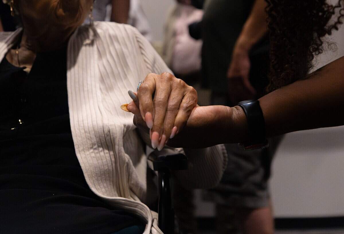 Opal Lee, civil rights activist, left, embraces hands with Dr. "T" Taylor during the Juneteenth press conference at the Bob Bolen Public Safety Complex on Thursday, June 18, 2026. In 2024 Lee was awarded the Presidential Medal of Freedom.