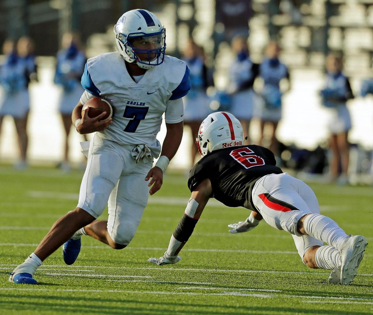 Southwest Christian quarterback Tyson Flowers maneuvers past Fort Worth Christian linebacker Cooper Ostrowsky (6) during the TAPPS Division II Regional Final at Castleberry High School in Fort Worth, Texas, Saturday, Dec. 05, 2020. Southwest Christian Lions defeated Fort Worth Christian Cardinals 35-28. (Special to the Star-Telegram Bob Booth)