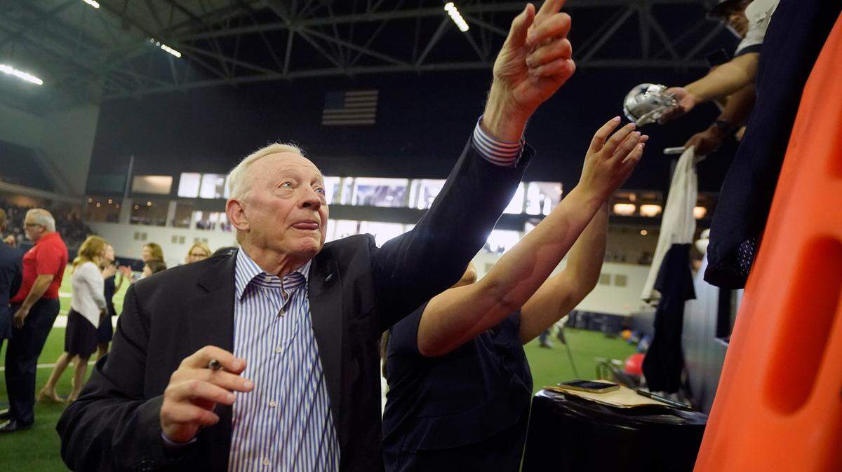 Dallas Cowboys owner Jerry Jones signs autographs for fans before an NFL football practice in Frisco, Texas, Monday, Aug. 16, 2021. Jones is just one of the several richest people who call North Texas home.
