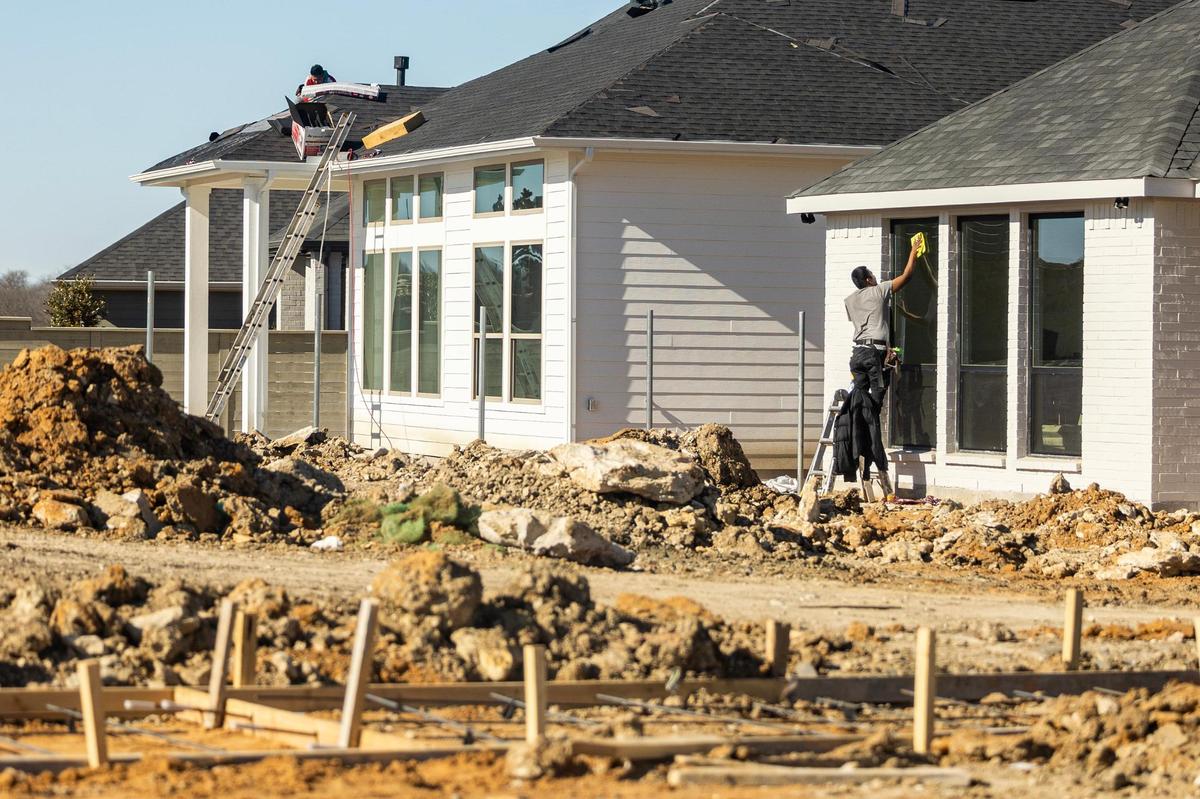 Construction workers building homes at the new Treeline development in January. Hillwood plans to construct 2,700 houses in the master-planned community.