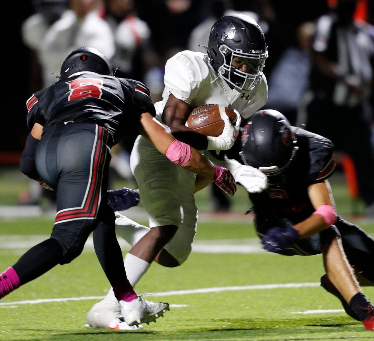 Pantego wide receiver Reiss Vickers (4) is pancaked by Dallas Covenant defensive backs Jeb Habashy (8) and Jacob Scott (5) on a run during a high school football game at Dallas Covenant in Dallas, Texas, Friday, Oct. 16, 2020. Pantego defeated Dallas Covenant 35-7. (Special to the Star-Telegram Bob Booth)