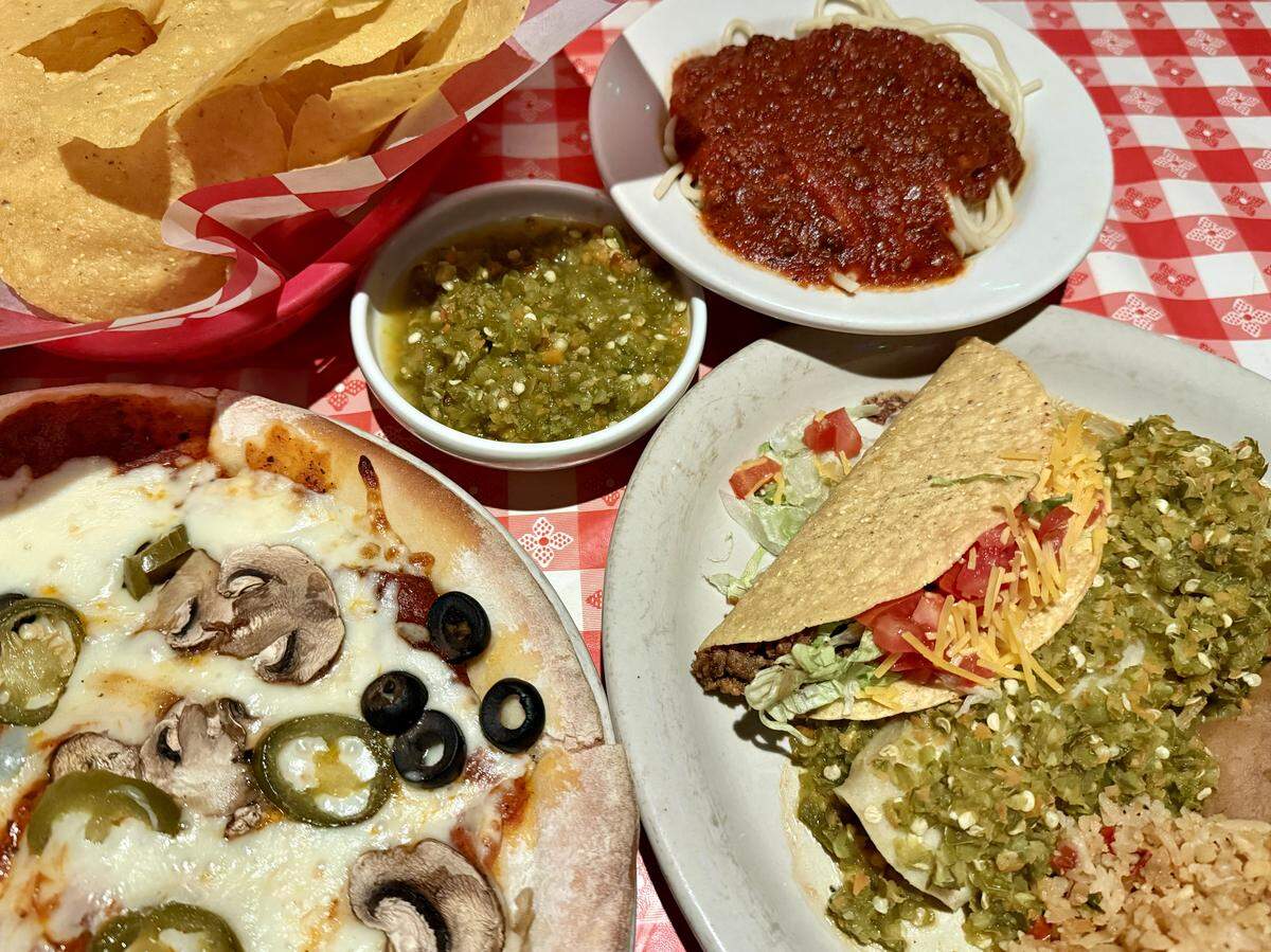 Pizza, Tex-Mex combination dinners (with the restaurant’s signature spicy green sauce) and spaghetti, top, are among the menu choices at the Candlelite Inn restaurant, open since 1957 on East Division Street in Arlington, Texas. Seen Dec. 8, 2025.