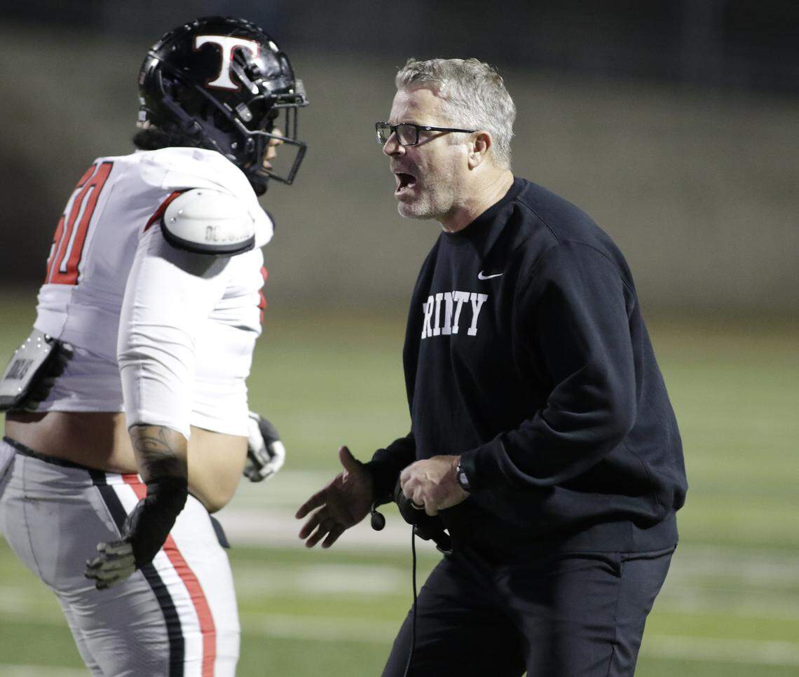 Euless Trinity head coach Aaron Lineweaver shouts encouragement during their Class 6A Division I bi-district game against Mansfield Lake Ridge on Friday, November 14, 2025 at Newsom Stadium in Mansfield Texas.