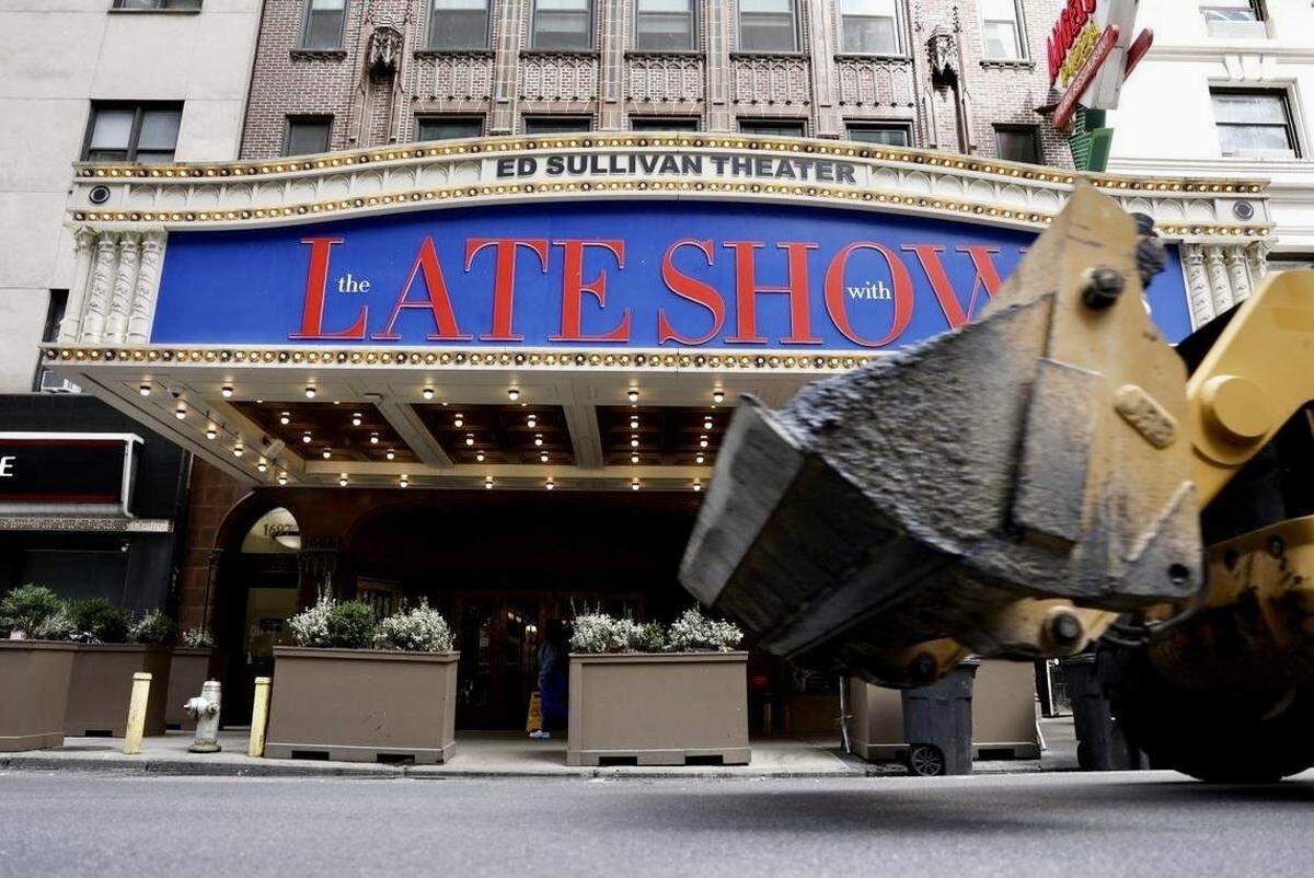 A bulldozer drives past the marquee at the Ed Sullivan Theater, home of “The Late Show,” on July 18, 2025.