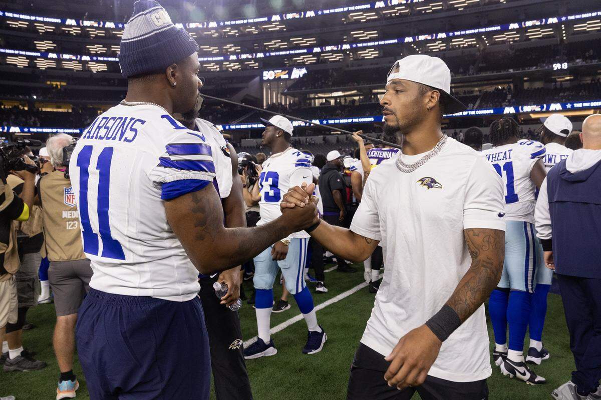 Cowboys defensive end Micah Parsons (11) greets Ravens wide receiver Tylan Wallace after an NFL preseason game between the Dallas Cowboys and the Baltimore Ravens at AT&T Stadium in Arlington on Saturday, Aug. 16, 2025,