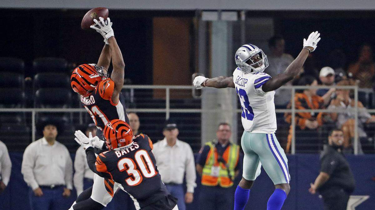 Cowboys wide receiver Michael Gallup leaps for an overthrown pass as Bengals defensive back Darqueze Dennard, left, tries for the pick in the second quarter of Saturday’s preseason game at AT&T Stadium.