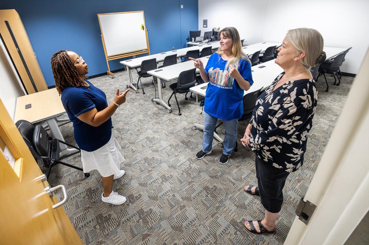 Social studies teacher Dawn Harris, left, English language arts teacher Debbie Garrett, middle, and Math teacher Frankye Bruce, right, share a conversation at the New Heights Adult High School in Fort Worth on Aug. 9. New Heights is operated by Tarrant County College and will enable adults ages 18-50 to simultaneously earn a full high school diploma and job certification in one of at least 10 career and technical programs.