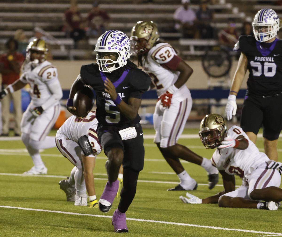 Paschal quarterback Jashaun Thomas (5) scrambles out of the backfield during the first half of a UIL football game between Saginaw and Paschal at Farrington Field in Fort Worth, Texas, Thursday, October, 16, 2025.