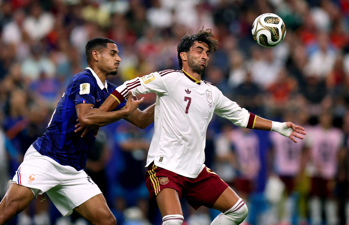 France defender Maxence Lacroix (26) and Spain forward Ferran Torres compete for a header during the 2026 FIFA World Cup semifinal on Tuesday, July 14, 2026, at Dallas Stadium in Arlington.